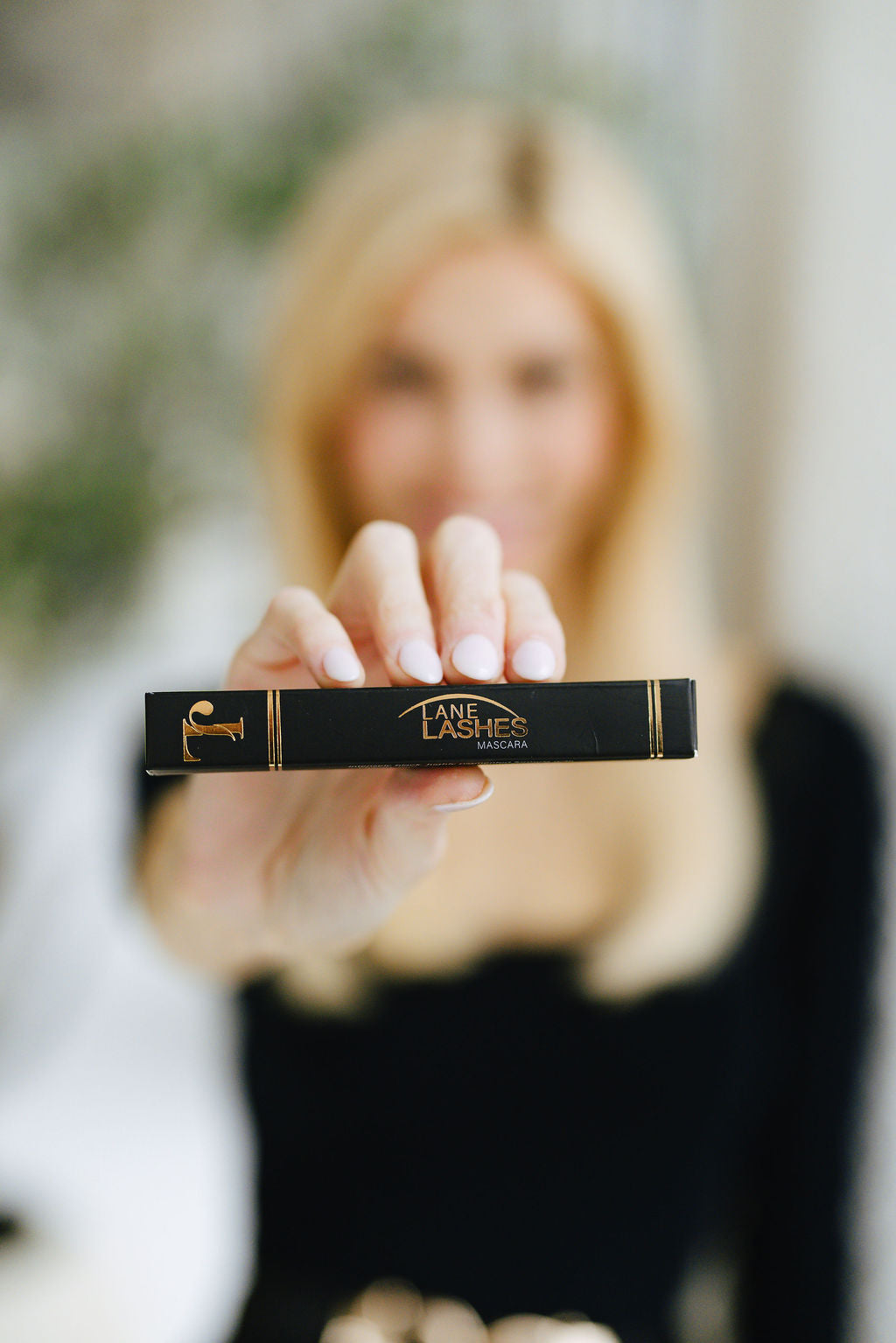 Founder Jennifer Lane holding the Lane Lashes Mascara product box