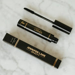 Jennifer Lane Beauty's Lane Lashes mascara on a white marble surface